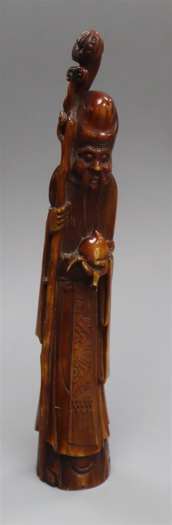 A 19th century Chinese stained marine ivory figure of Shou Lao
